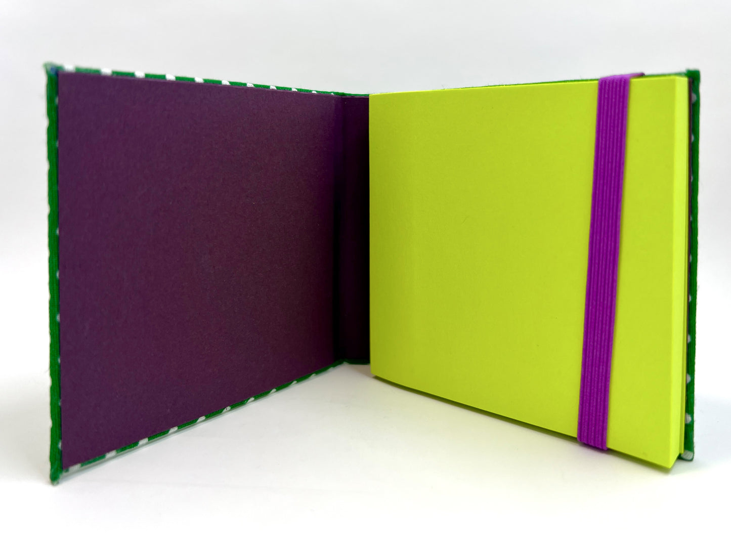 Absynth - OPEN - Deep Purple accents with neon green note pad.